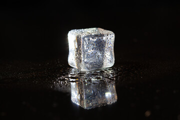 ice cubes on black table background.