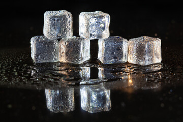 ice cubes on black table background.