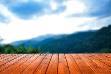 wooden table with mountain scenery backdrop