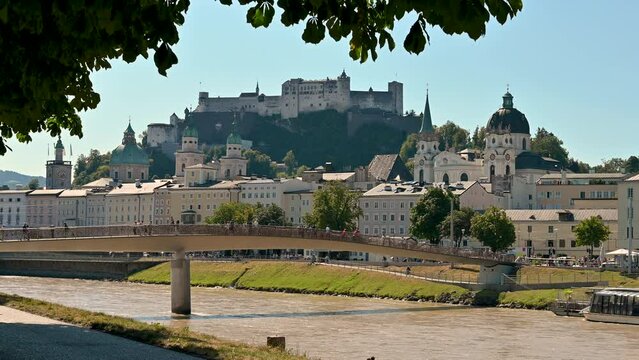 Salzburg, Austria, August 2022. Amazing daytime footage with a view of the old town framed by the trees and the river. Beautiful summer day.