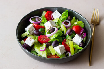 Greek salad with feta cheese, tomatoes, cucumbers, peppers and Kalamata olives. Healthy eating. Vegetarian food.
