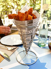 presentation in a cone of squid fingers in a restaurant