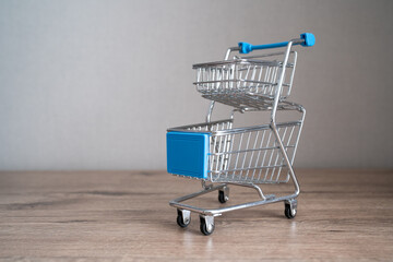 empty shopping cart, supermarket trolley, concept of saving money, reduced income, less spending, poverty, crisis 