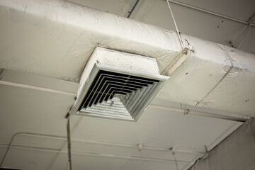 old air conditioner hole pipe vent with grill air flow distributor in office need to clean