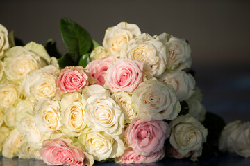 Bouquet of white roses close-up in beige tones.