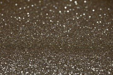 Extreme close-up, flat piece of sparkly, vibrant, gold, coloured craft paper, shallow...