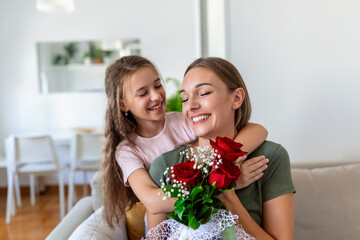 Fototapeta na wymiar I love my you mom! Attractive young woman with little cute girl are spending time together at home, thanking for handmade card with love symbol and flowers. Happy family concept. Mother's day.