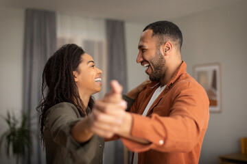 Happy Dating Black Couple Dancing Having Fun Together At Home