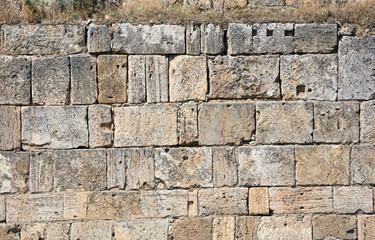 Ancient brick wall made of stone as an abstract background.