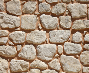 Ancient brick wall made of stone as an abstract background.