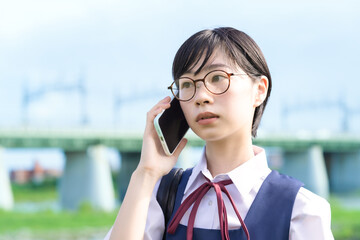 スマートフォンを使う女子高生