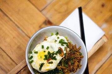 Fried noodles with fried egg and red chili