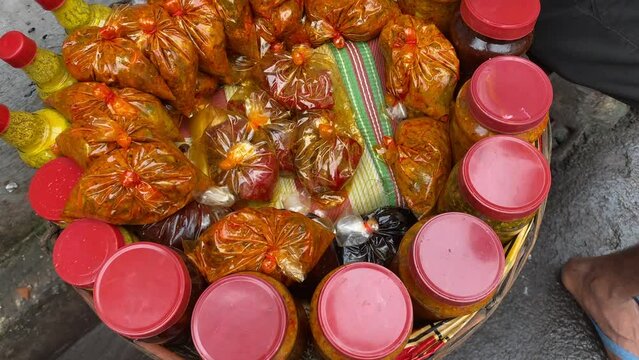 A vendor selling pickle made from mango and spices packed in plastic bag in the street of Kolkata