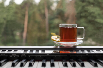 Tea with lemon near the window and piano