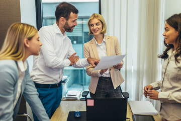Office colleagues having discussion during meeting in conference room.