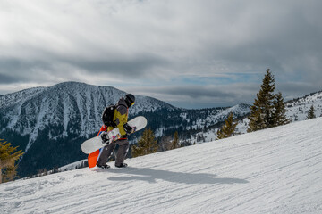 man snowboarder with slovakia flag at ski resort slope