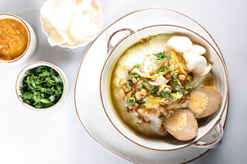 Bubur Ayam or Indonesian Rice Porridge with Shredded Chicken, cheese stick and cakwe.