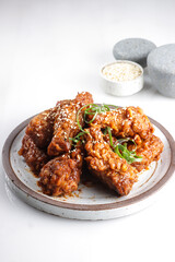 Korean Fried Chicken Yangnyeom Tongdak with Spicy Sauce and Sesame Seed. Sayap ayam pedas Korea.
