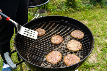 Selective focus of fresh delicious burger cutlets grilling on bbq grill