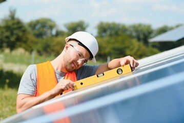 A man working at solar power station.