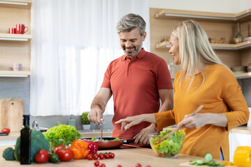 Cheerful family enjoying cooking together at home