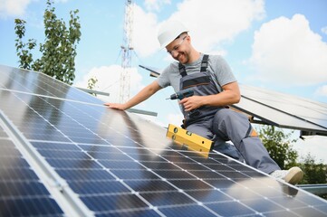 Worker installing solar panels outdoors