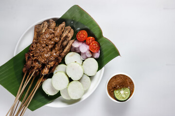 Chicken Satay or Sate Ayam is a dish of seasoned, skewered and grilled meat, served with a peanut sauce
