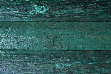 dark green wooden background, wet boards top view, backdrop of old blue-green boards, desk surface