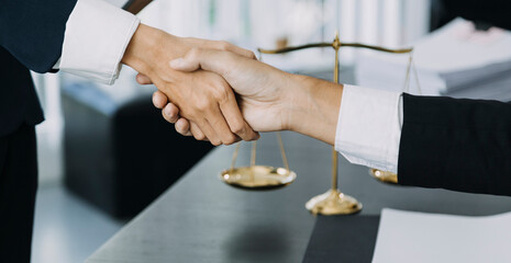 Justice and law concept. Gavel on sounding block in hand's Male judge at a courtroom, working with document law books, report the case on table in modern office.