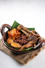 Gudeg Komplit. A Signature and Legendary Dish from Yogyakarta Indonesia. Jack Fruit Stew Accompanied with Spicy Stew of Cattle Skin Crackers and Brown Eggs, Tofu and Chicken.