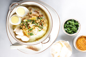 Bubur Ayam or Indonesian Rice Porridge with Shredded Chicken, cheese stick and cakwe.