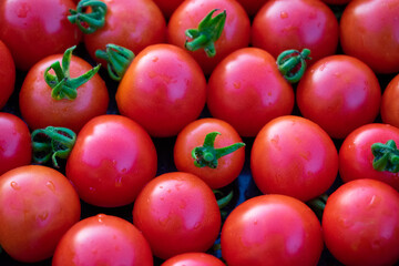 Tomatoes lying on a pile on top of each other, tomato texture. Selective focus.