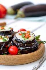 Baked eggplant, tomatoes and cheese on table. Vertical view