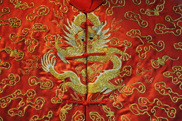 A Chinese dragon is embroidered on traditional clothing.