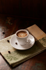 Cup of coffee on dark wooden background. Copy space.