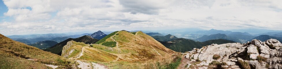Beautiful panorama photography from a Slovakia mountains, nice weather, white clouds in a blue sky and stones and walley trough the mountains