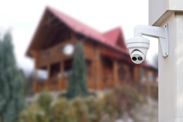 Security camera and private house on the background.