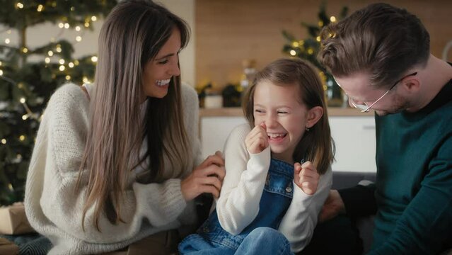 Caucasian family spending time together at home in Christmas time. Shot with RED helium camera in 8K. 