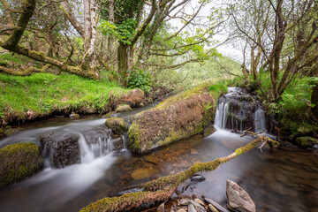 Long exposure of a waterfall on the Weir water river at Robbers Bridge in Exmoor National Park