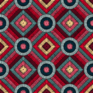 Seamless pattern in patchwork style. Embroidered print for carpet, textile, wallpaper, wrapping paper. Ethnic and tribal motifs. Handwork. Vector illustration.