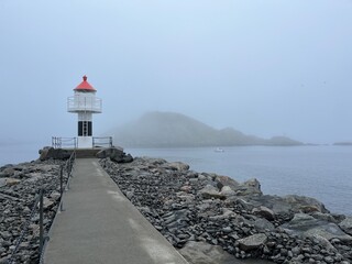 Sea lighthouse in the fog, seascape background