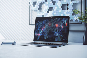 Close up of laptop at designer workplace with creative forex grid map on blurry background. Trade, finance, market and invest concept. 3D Rendering.
