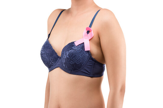 A woman in a blue bra shows a pink awareness ribbon