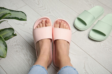 Woman wearing comfortable rubber slippers indoors, closeup