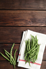 Fresh green beans on wooden table, flat lay. Space for text