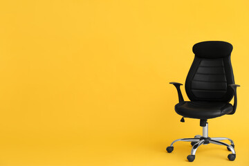 Modern office chair on yellow background. Space for text