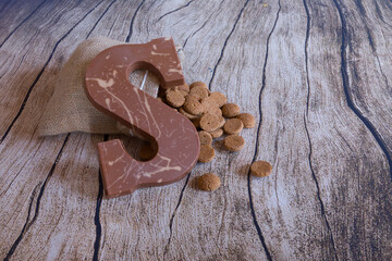 Dutch Sinterklaas tradition: A chocolate letter and a bag with candy called Pepernoten.