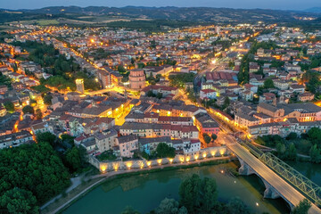 Obraz premium Old italian city Umbertide near Tevere river with cloudy sky and sunset light