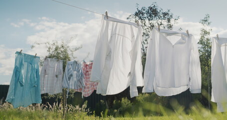 Wet clothes drying in the backyard of the house