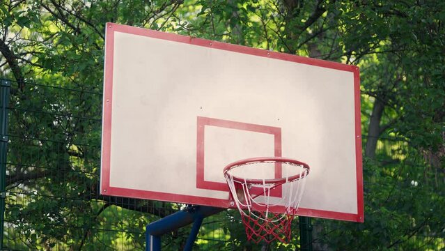 Ball misses basketball hoop, sport training outdoors, misfortune or loss concept